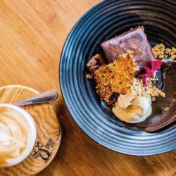 Coffee mousse with chocolate soil, honey comb passion fruit ice cream and sesame snap
