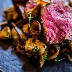 Miso crusted sirloin with wild mushrooms, garlic and herb gnocchi, burnt onion and roasted garlic puree